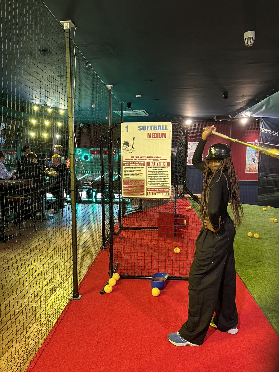 Guest batting in a Hit King cage against the softball pitching machine